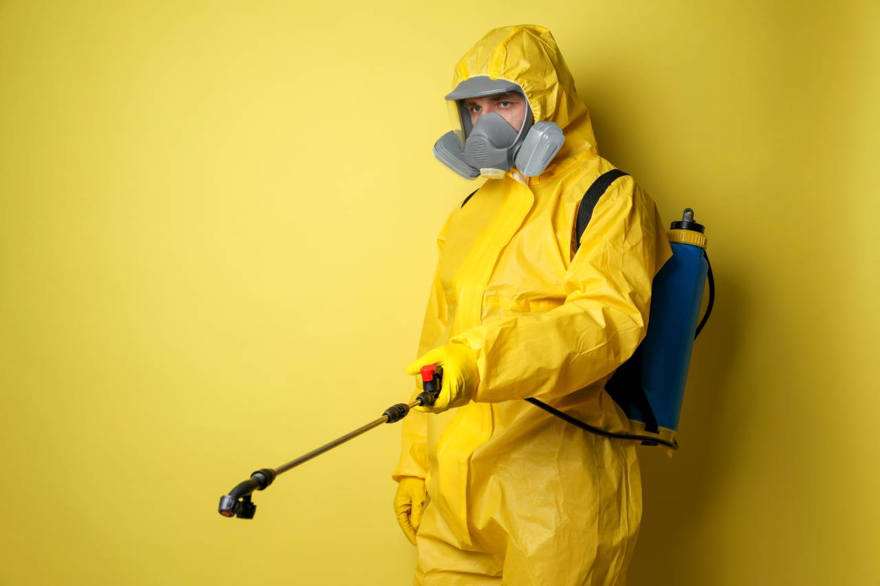 exterminator holding chemical spray